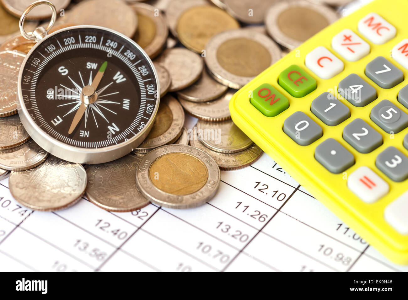 Close up Compass on coin stack Stock Photo - Alamy