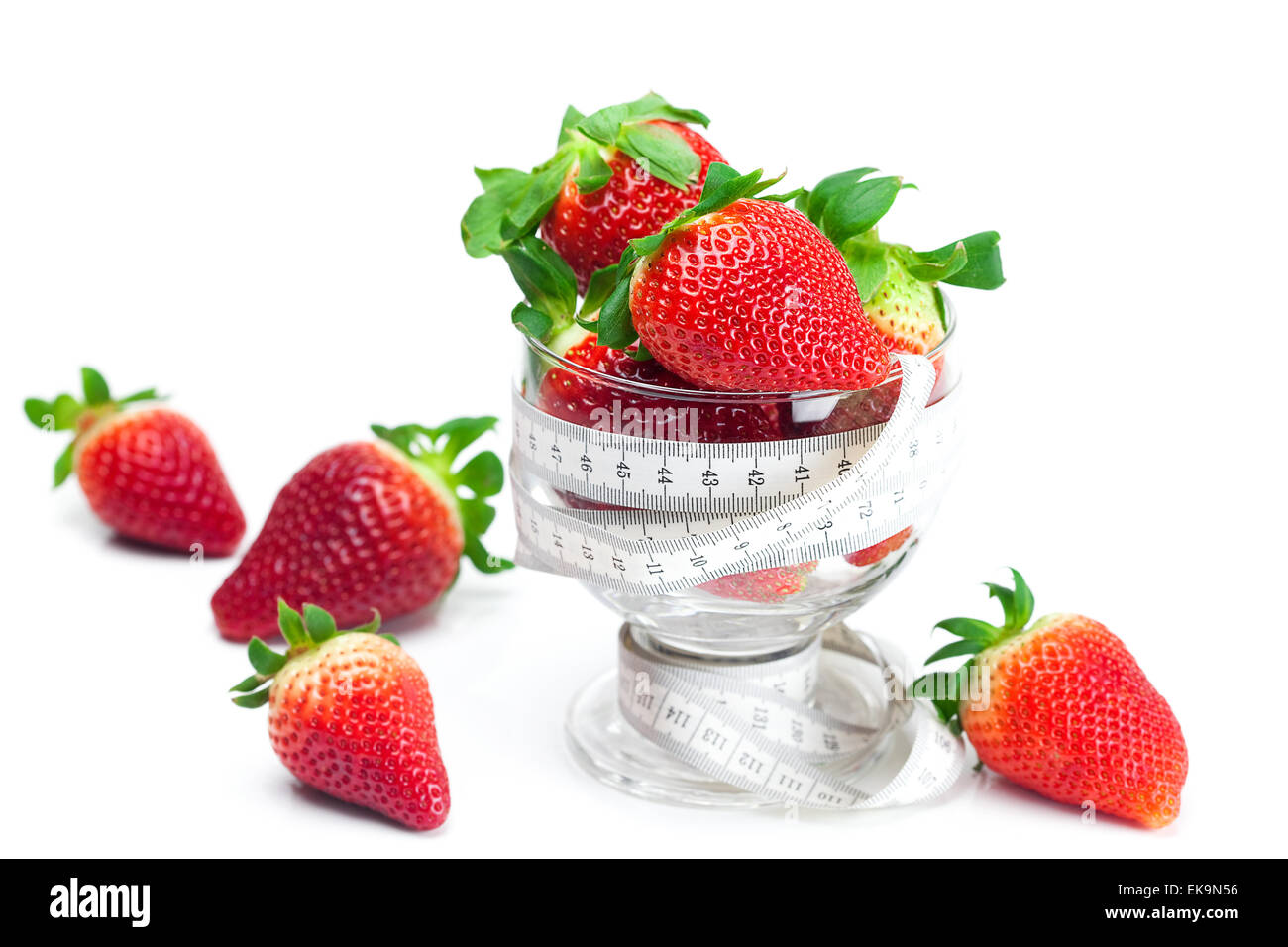 big juicy red ripe strawberries in a glass bowl and measure tape Stock ...
