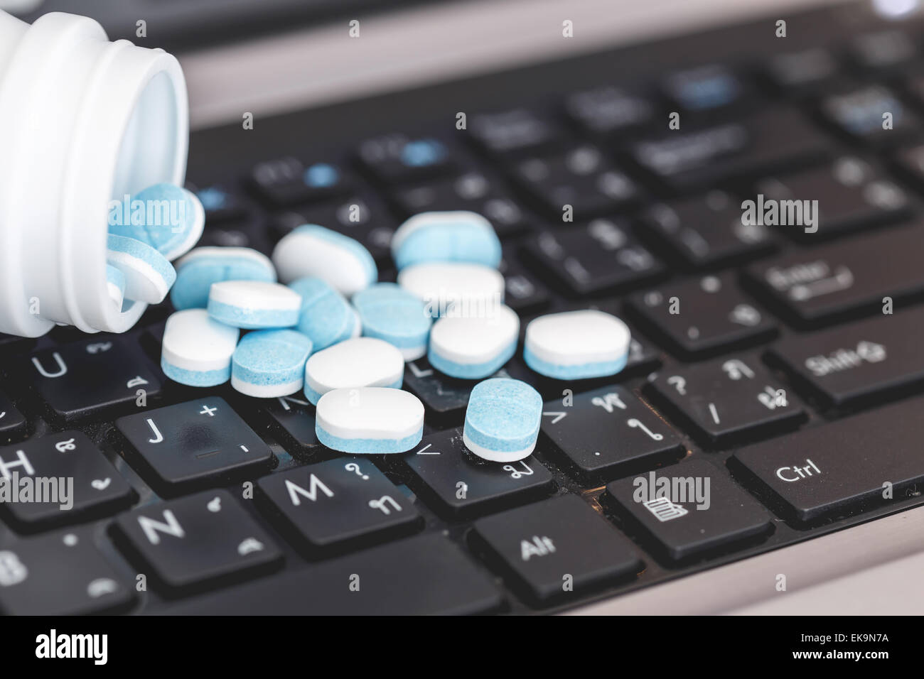 Close up Medicine pills on laptop, hard work concept Stock Photo - Alamy
