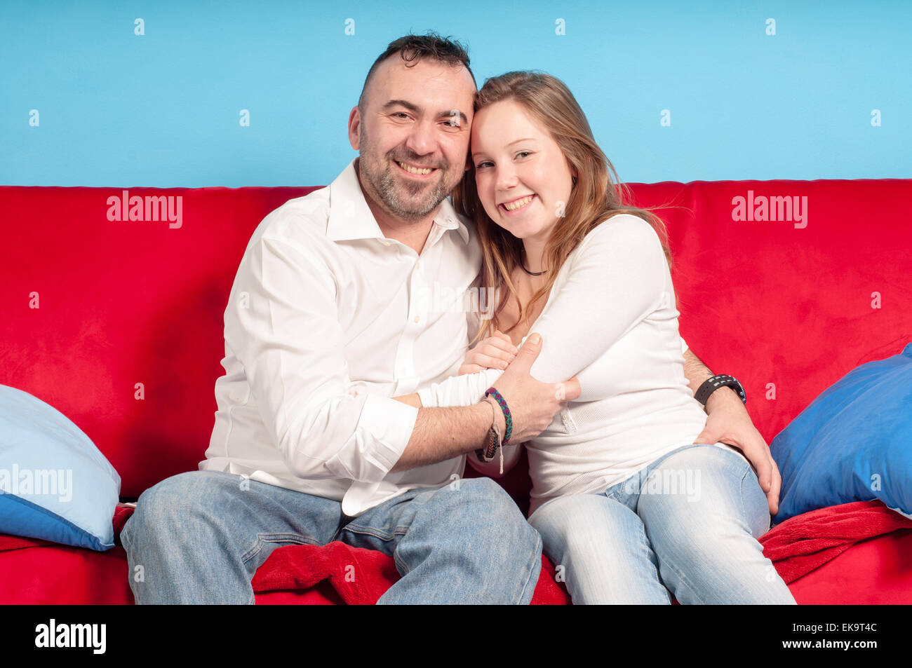 happy-father-and-teenage-daughter-on-the-couch-stock-photo-alamy