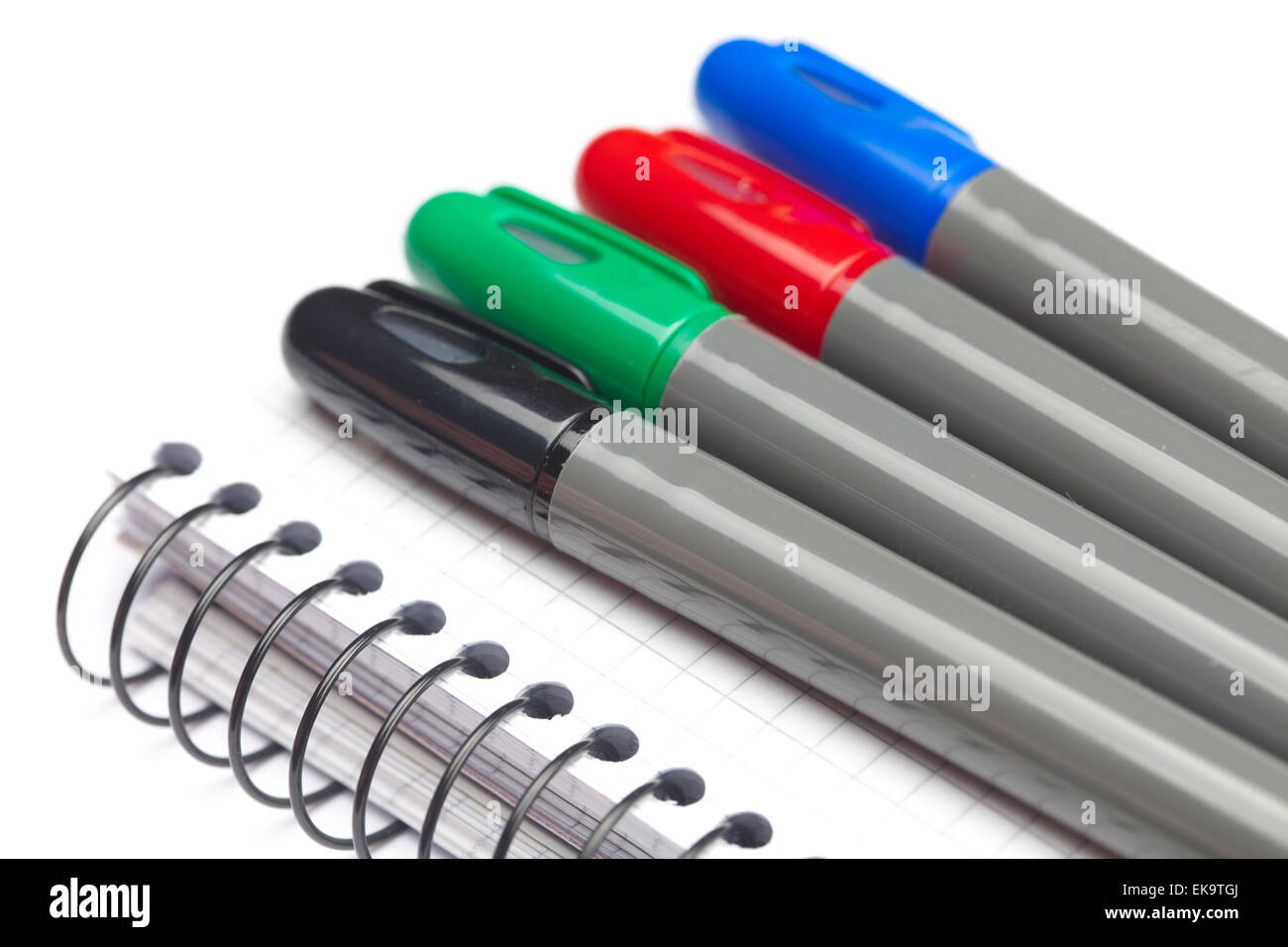 colored markers and a notebook isolated on white Stock Photo - Alamy