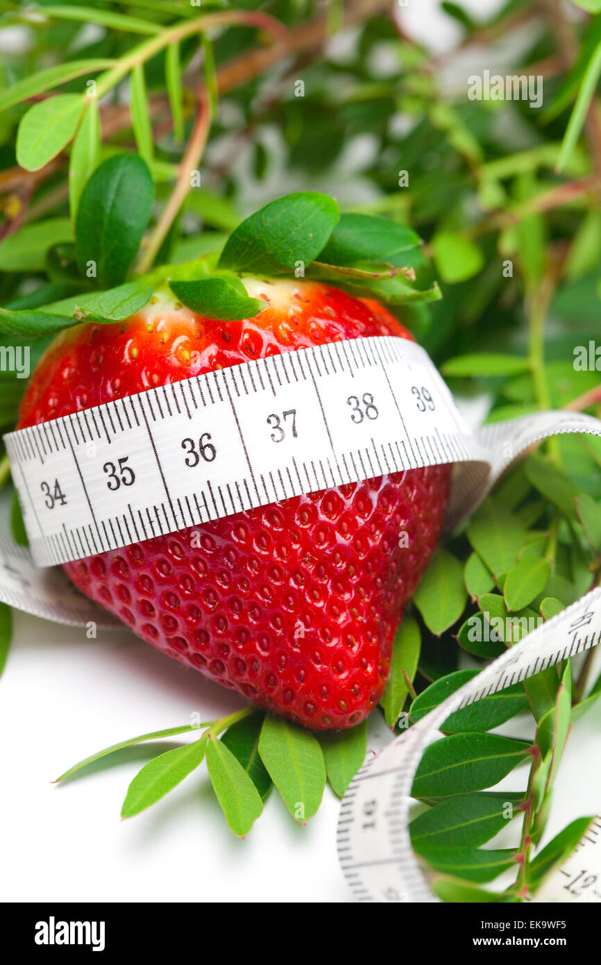 big juicy red ripe strawberries,flower and measure tape isolated Stock Photo