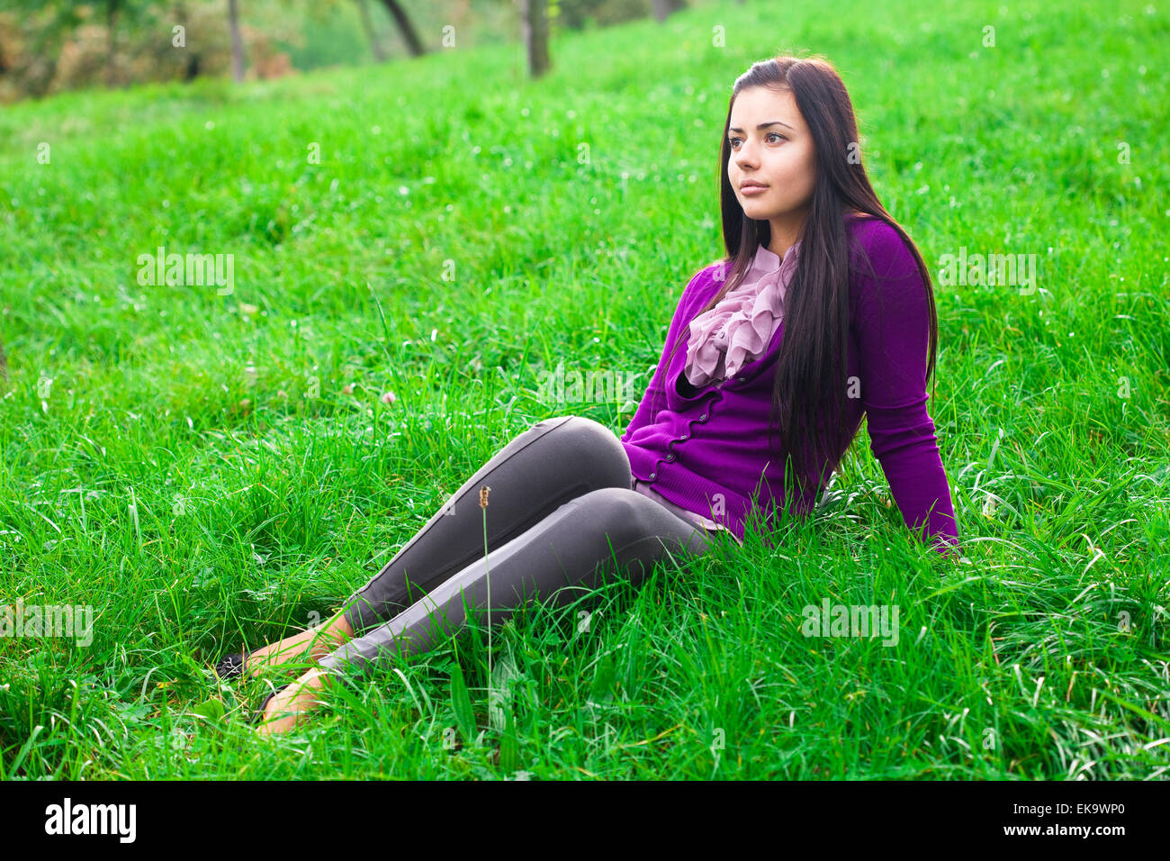 beautiful young woman lying on green grass Stock Photo - Alamy