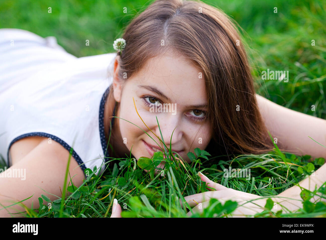 portrait of a beautiful young woman with flower outdoor Stock Photo - Alamy