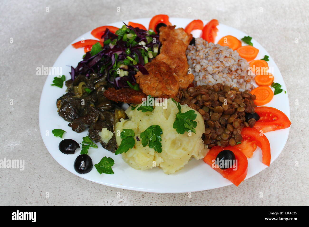 appetizing healthy vegetarian plate potato, buckwheat, soy, carrot, cabbage, tomato, lentils, mushroom Stock Photo