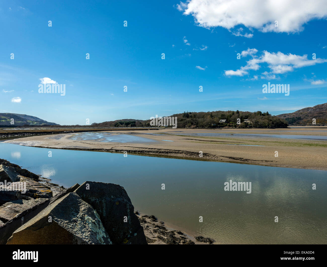 Landscape depicting Afon Mawddach and Min Y Don area on a clear spring day with blue sky and banks of white cumulus cloud Stock Photo