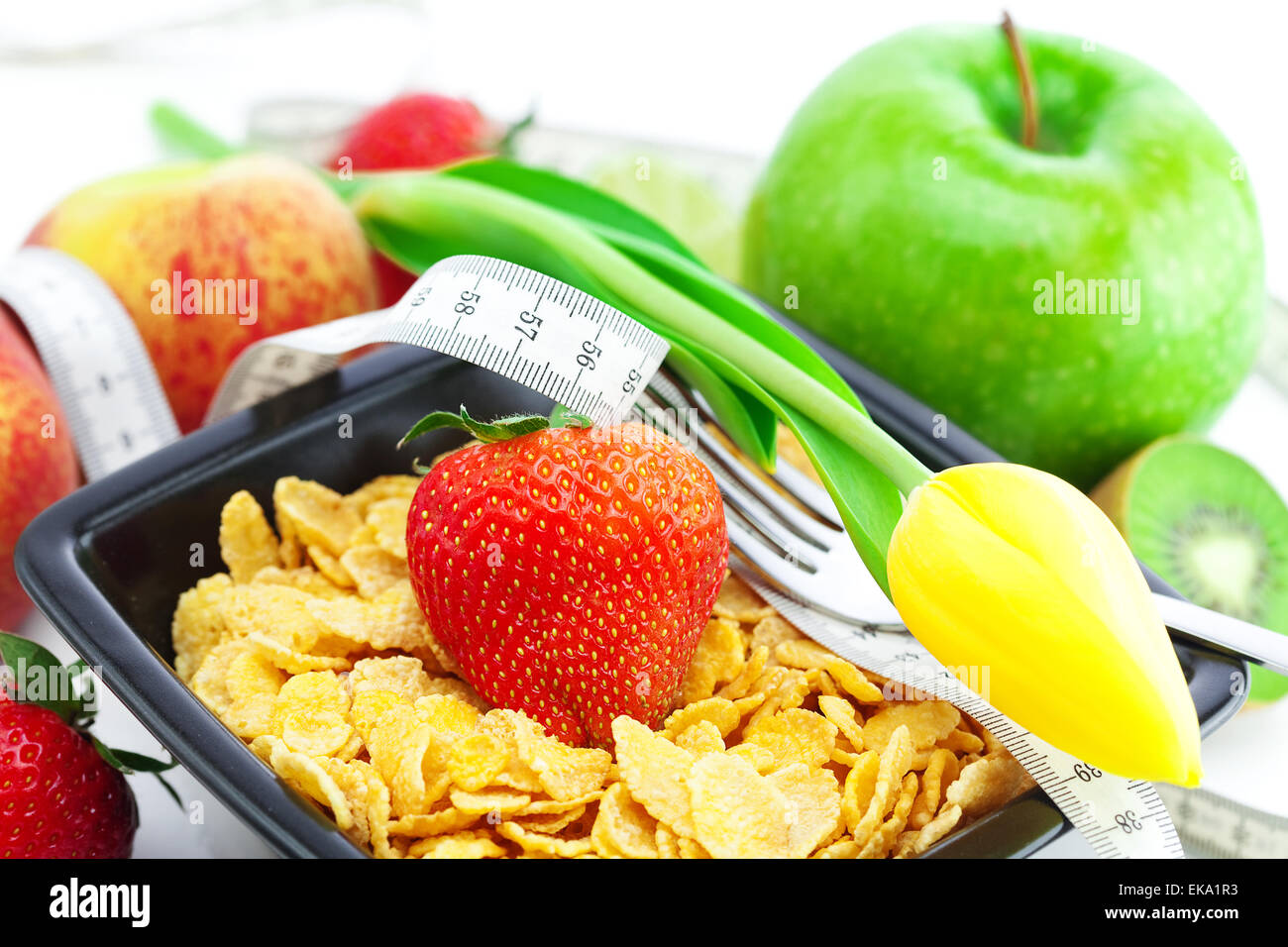 strawberry, peach, apple, kiwi fruit, tulips,measure tape and fl Stock Photo