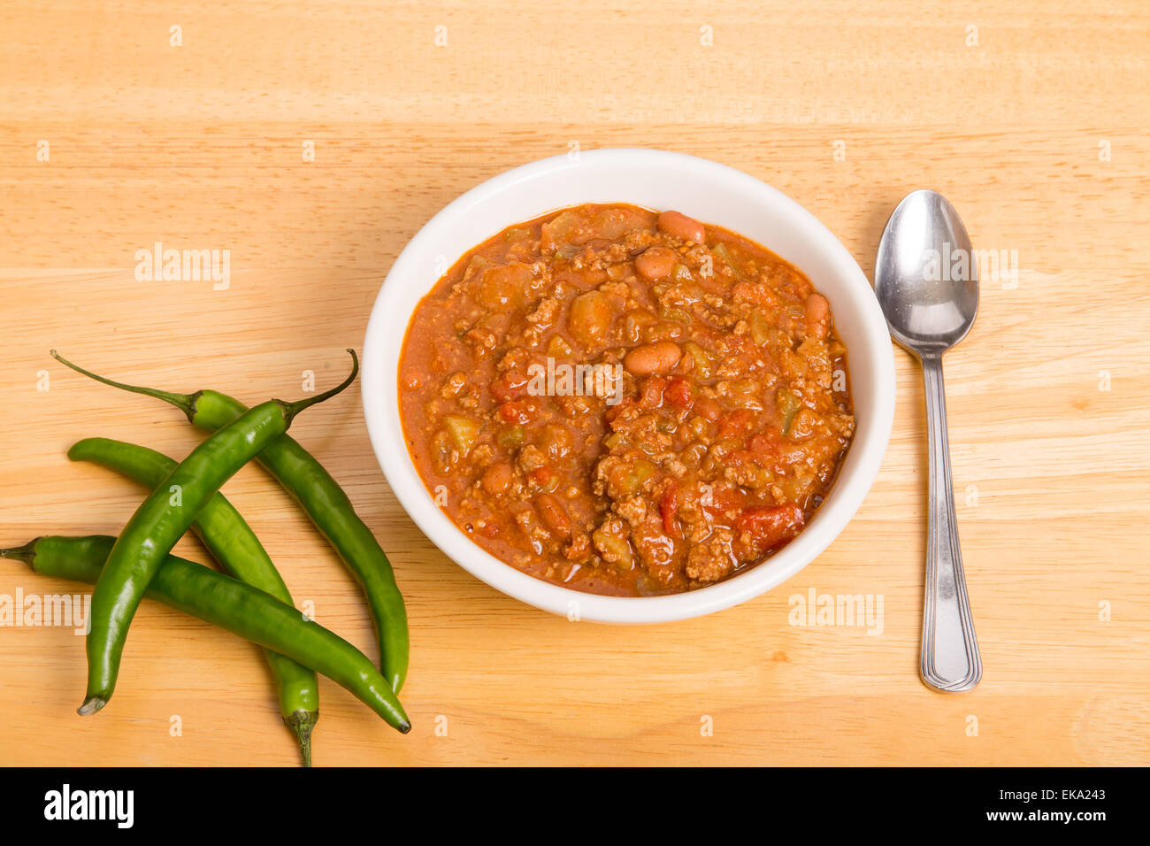 A bowl of chili con carne with beans and green chili peppers Stock Photo