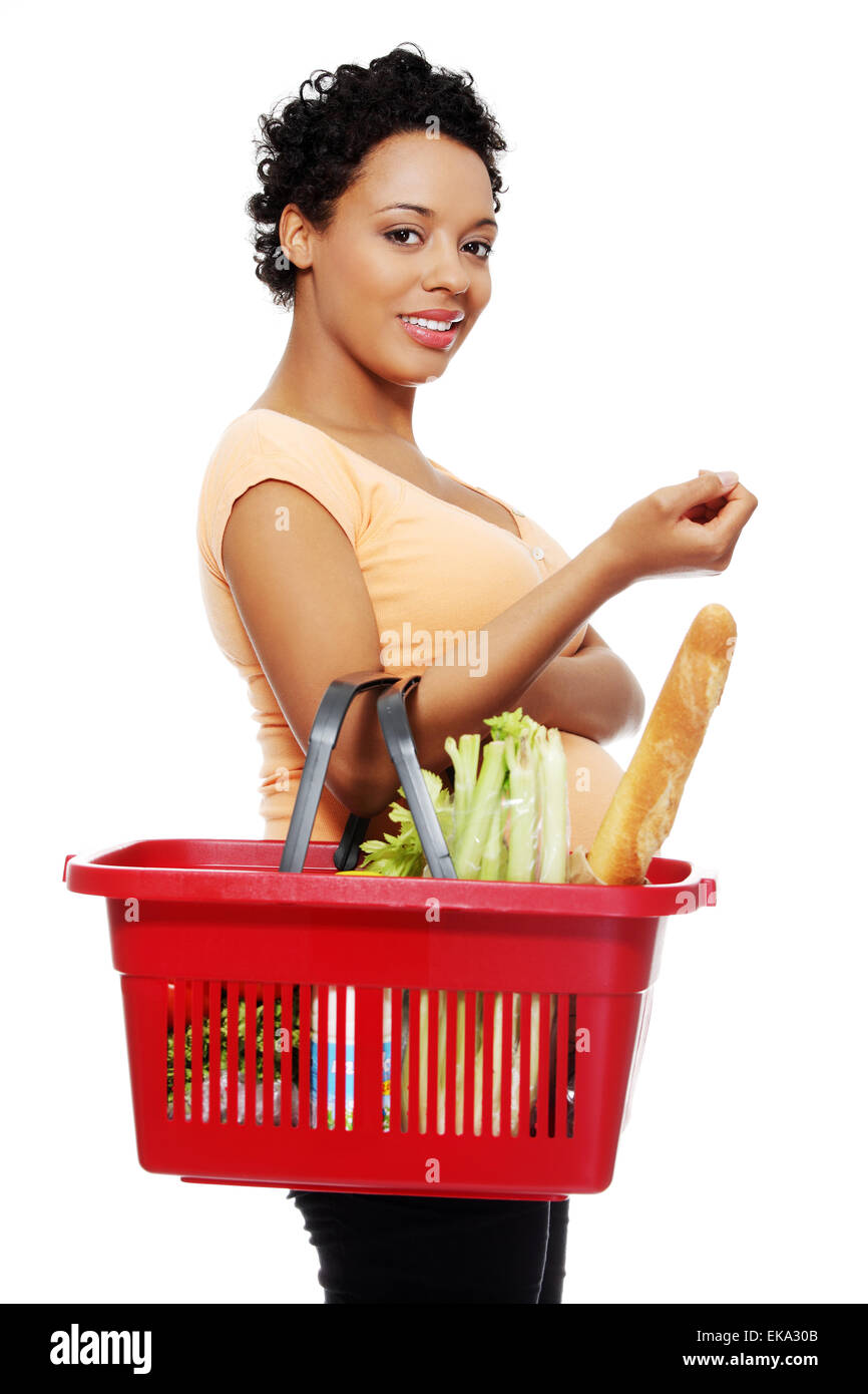 Pregnant woman with shopping basket Stock Photo - Alamy