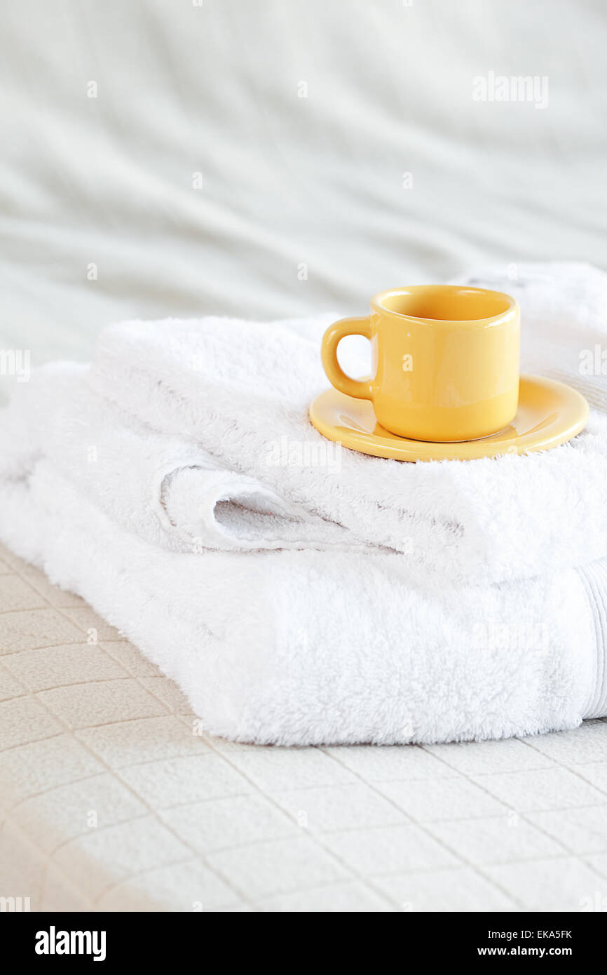 cup lying on towels on the bed Stock Photo Alamy