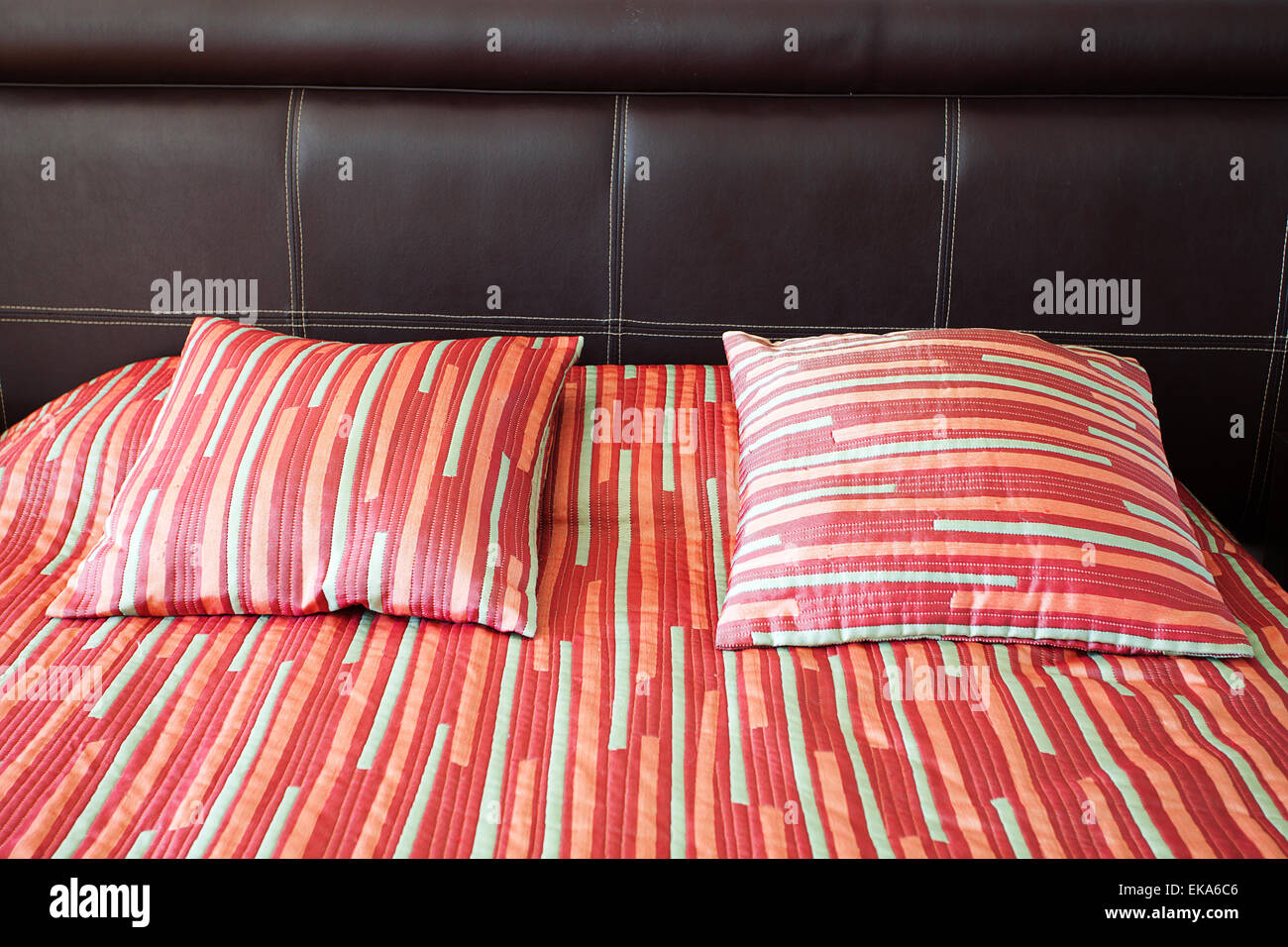 bed with two pillows and a blanket Stock Photo Alamy