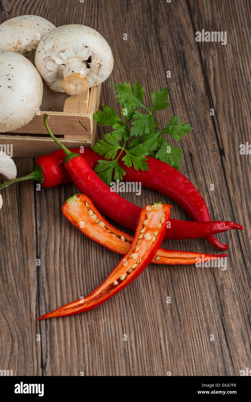 Red hot chili peppers on old wooden table Stock Photo - Alamy