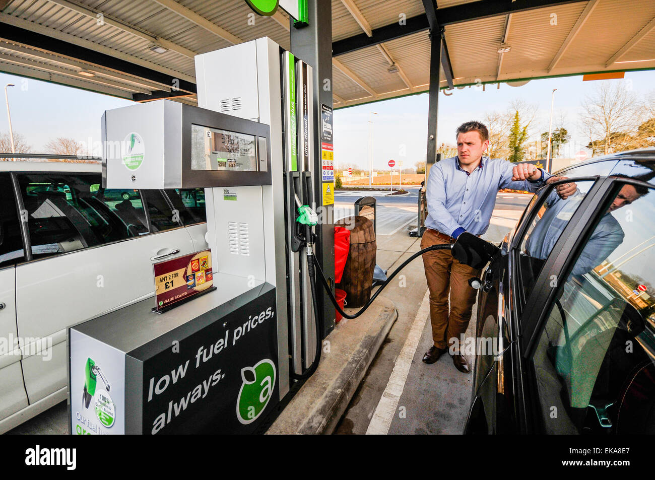 A man fills his car with diesel at an Applegreen motorway service station. Stock Photo