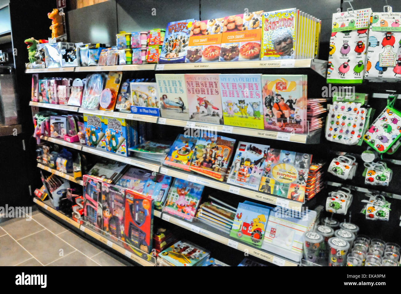 Children's books and toys on the shelves at the shop of a motorway service station Stock Photo