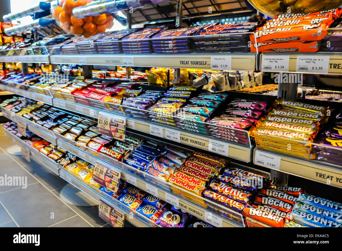 Sweets and chocolate bars on sale in a motorway service station shop Stock Photo
