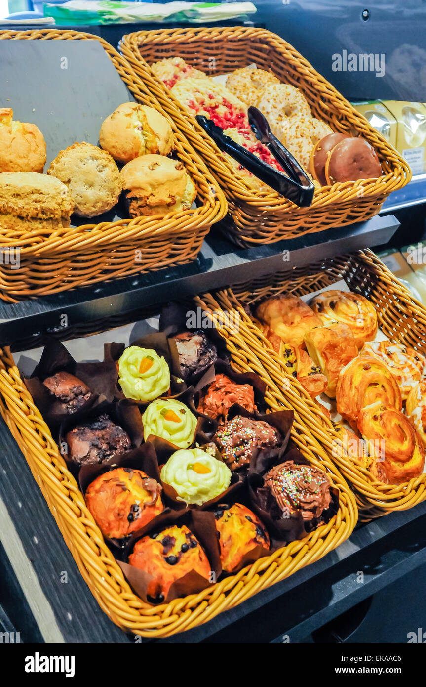 Scones, donuts, muffins and danish pastries on sale at a motorway ...