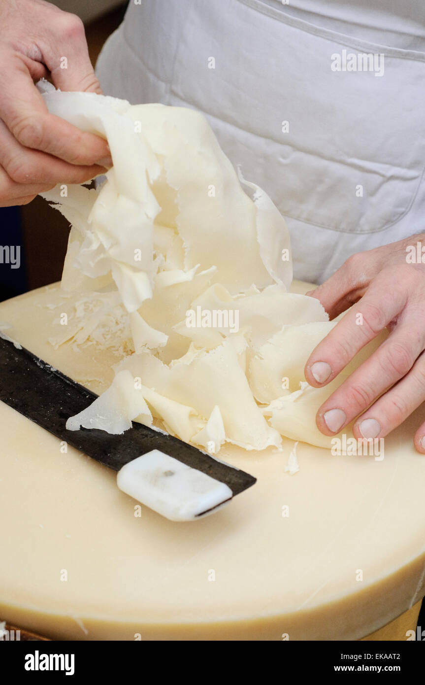 Italy, Lombardy, Lodi, Making of Raspadùra Cheese Sliced Young Parmesan