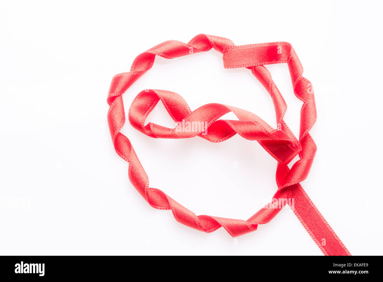 Red silk twisted ribbon in the form Stock Photo - Alamy