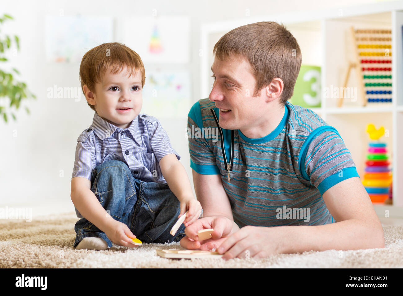 Child Boy And Father Play With Puzzle Toy Stock Photo - Alamy