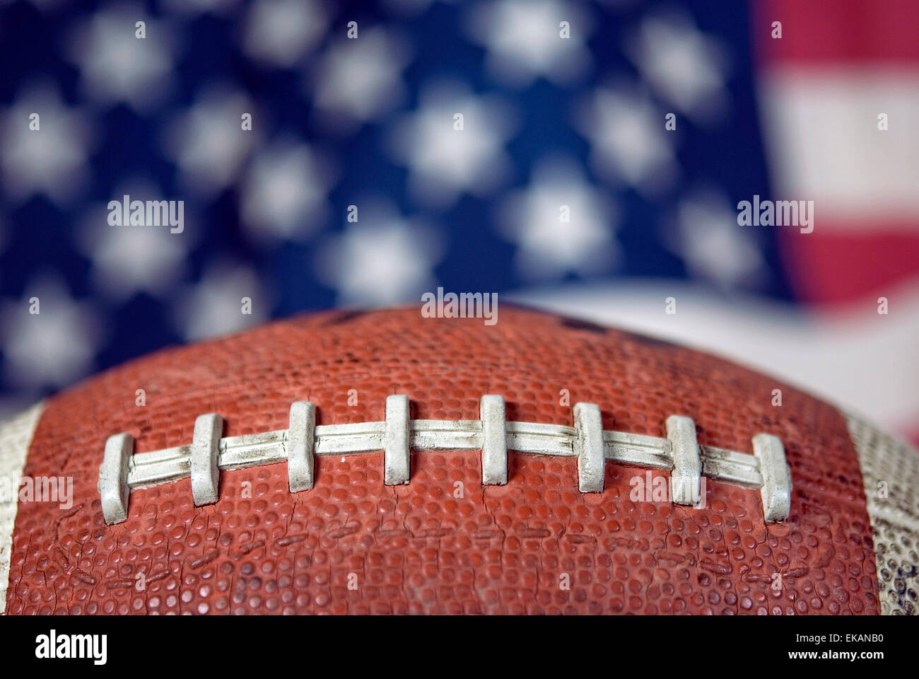 Close up of a football with American flag background. Stock Photo