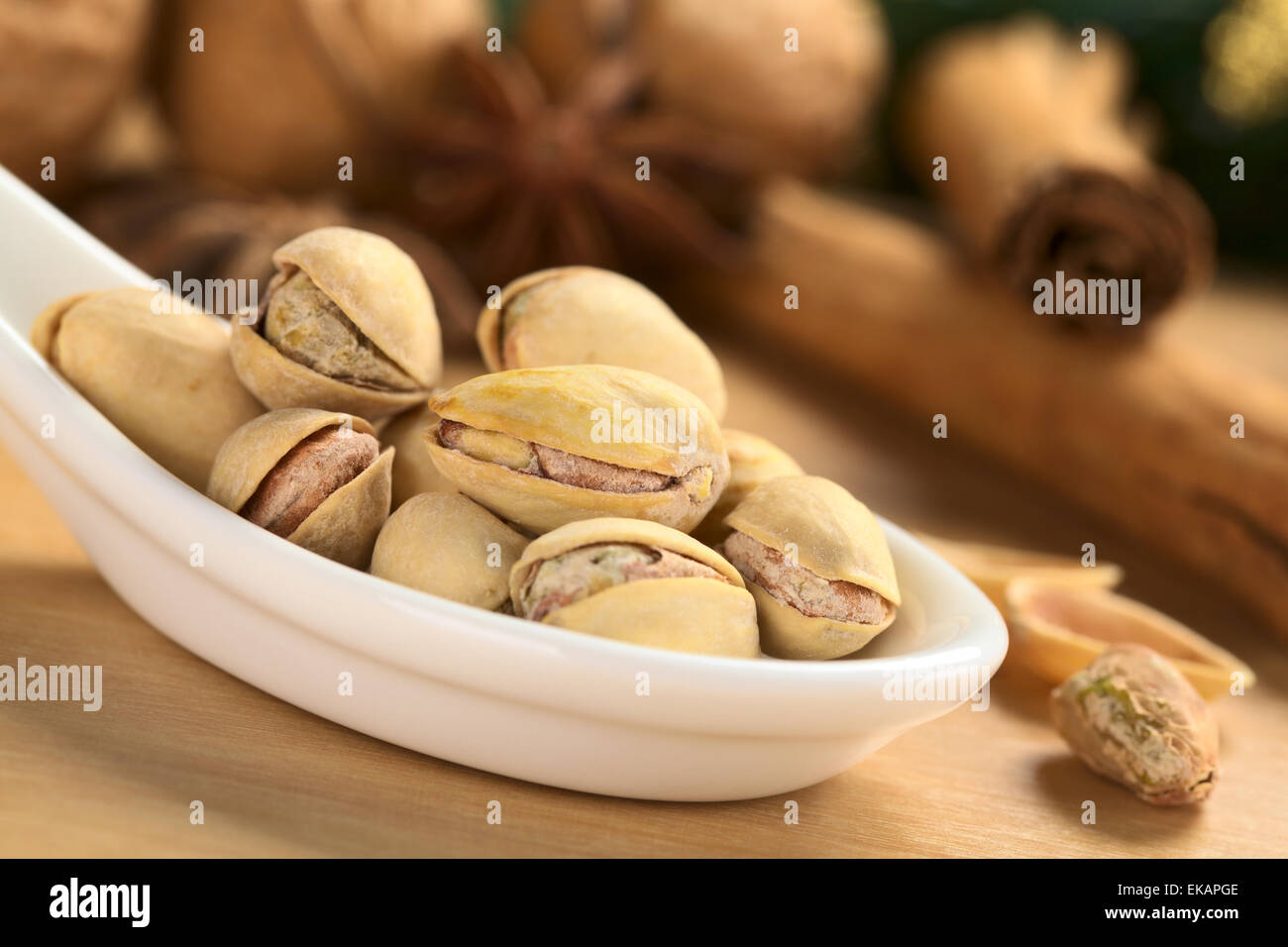 Roasted pistachio nuts with shell (Selective Focus, Focus on the front upper pistachio) Stock Photo