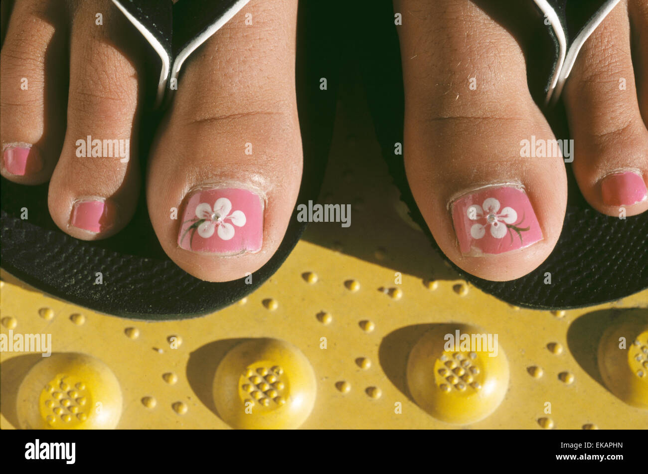Pedicure detail on female teen wearing flipflops Stock Photo Alamy