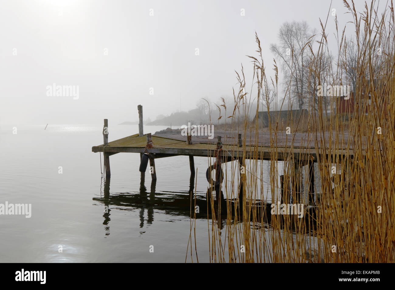 Silhouette of an old wooden bridge a foggy morning and flag in the ...
