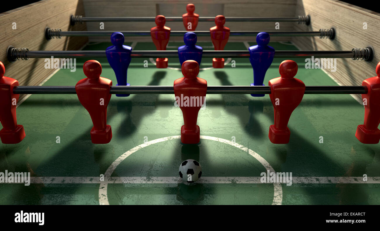 One half of a foosball table at ground level with a soccer ball in