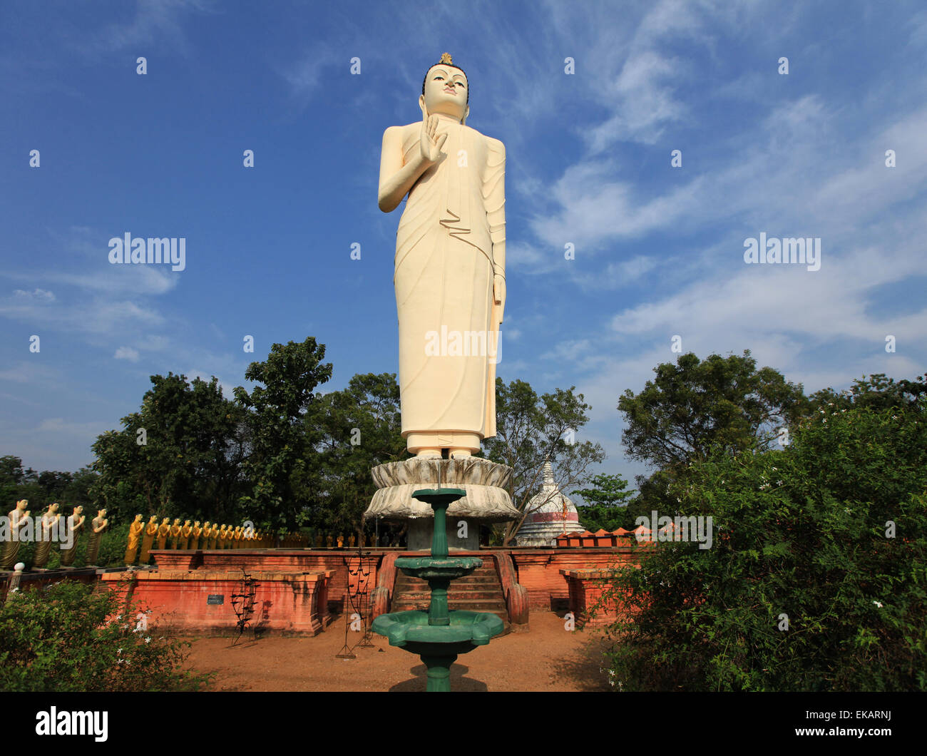 Tallest Statue of Buddha with golden statues in Sri Lanka Stock Photo