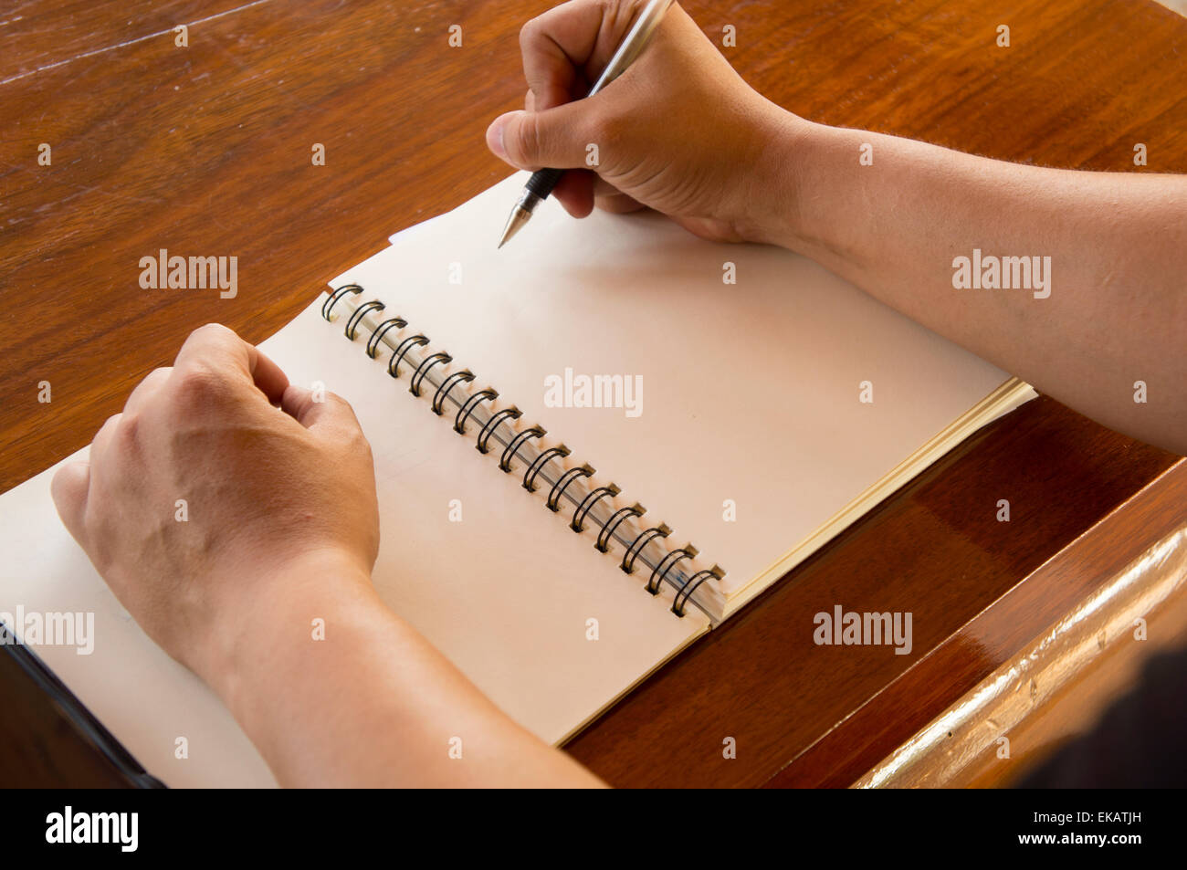 man working table book pen booklet top Stock Photo