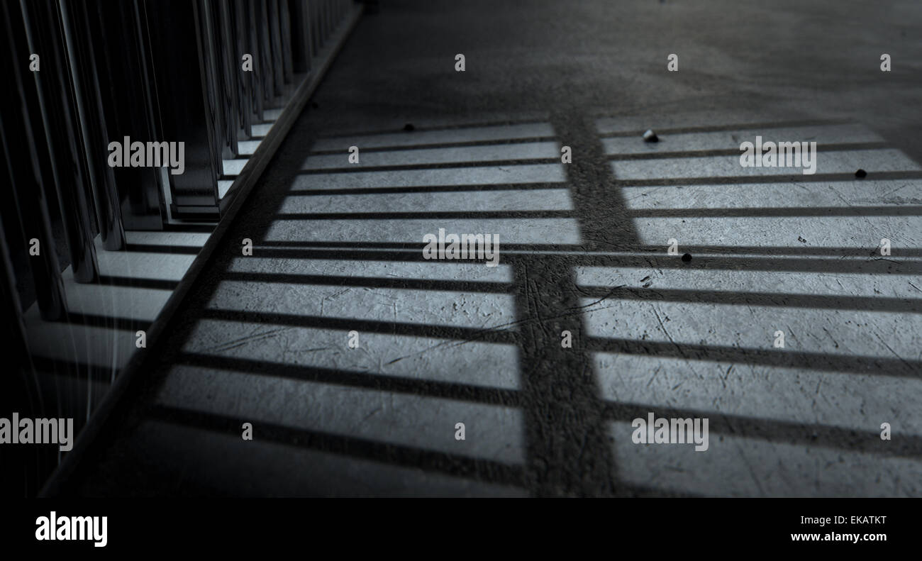 A closeup of view of a jail cells iron bars casting shadows on the prison floor with copy space Stock Photo