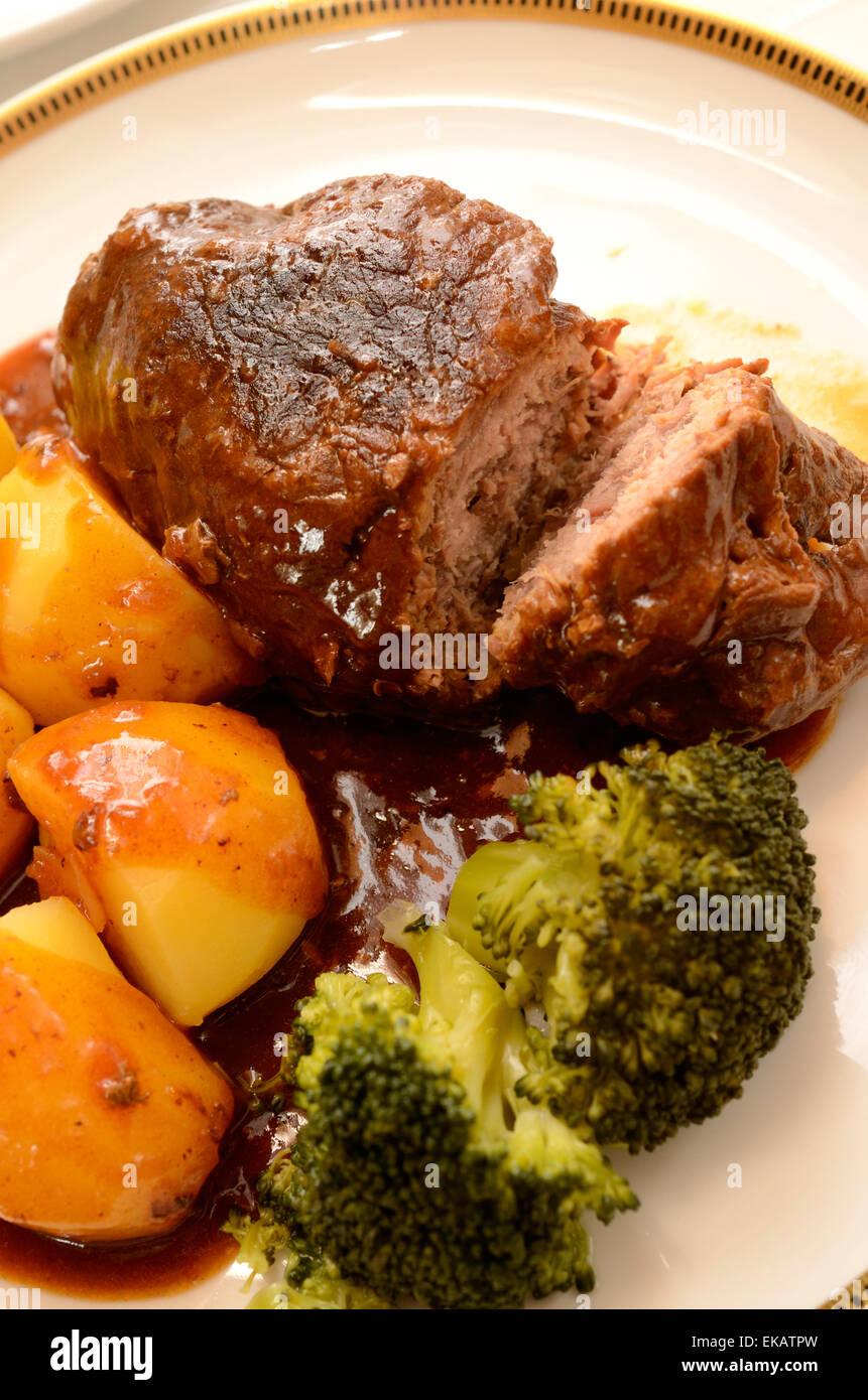 Beef roulade with potatoes and sauce on a luxury plate with golden decoration Stock Photo