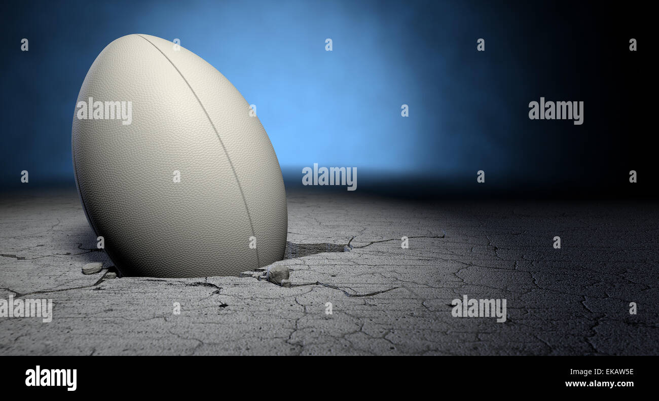 A white dimpled rugby ball stuck in a whole cracked in the ground on a ...