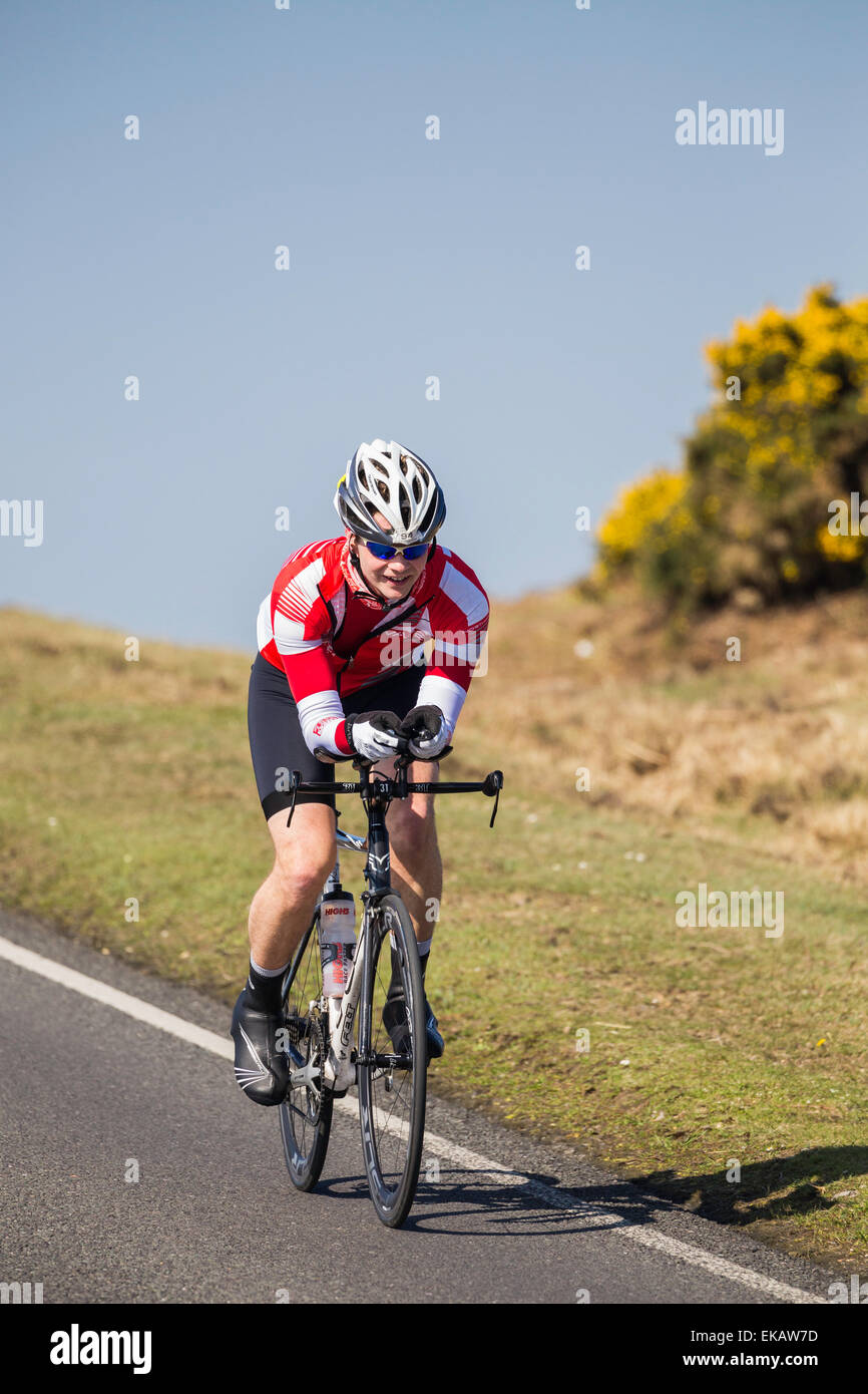 A male cyclist competes in the New Forest Wiggle Sportive event on a sunny Saturday in Spring Stock Photo