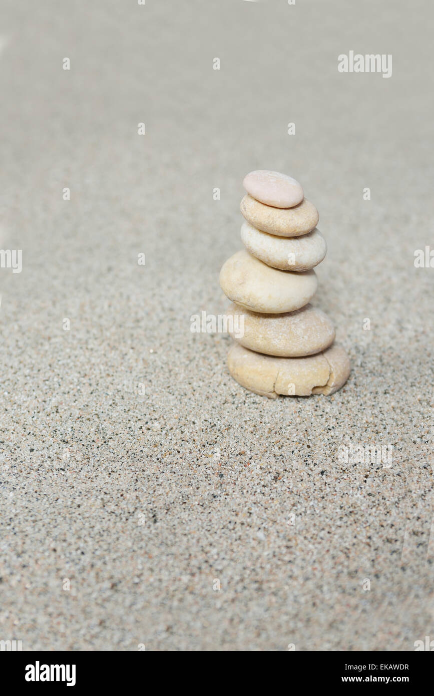 Balanced sand stones on beach sand over Stock Photo