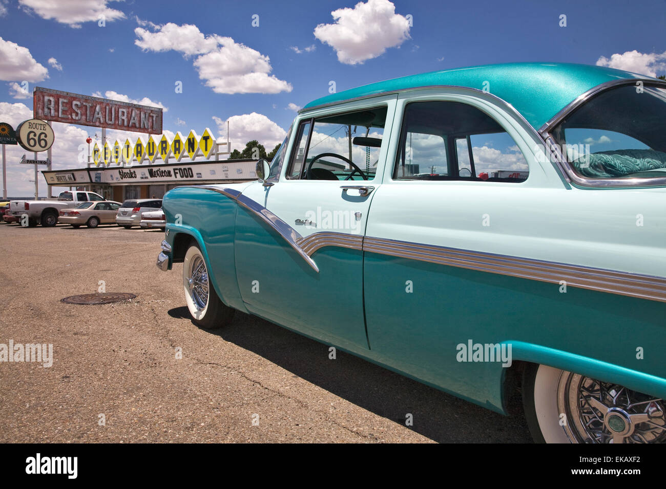 A two toned 1956 Ford Club Sedan gleams in the sun in front of a period diner on old Route 66 in Santa Rosa, New Mexico. Stock Photo