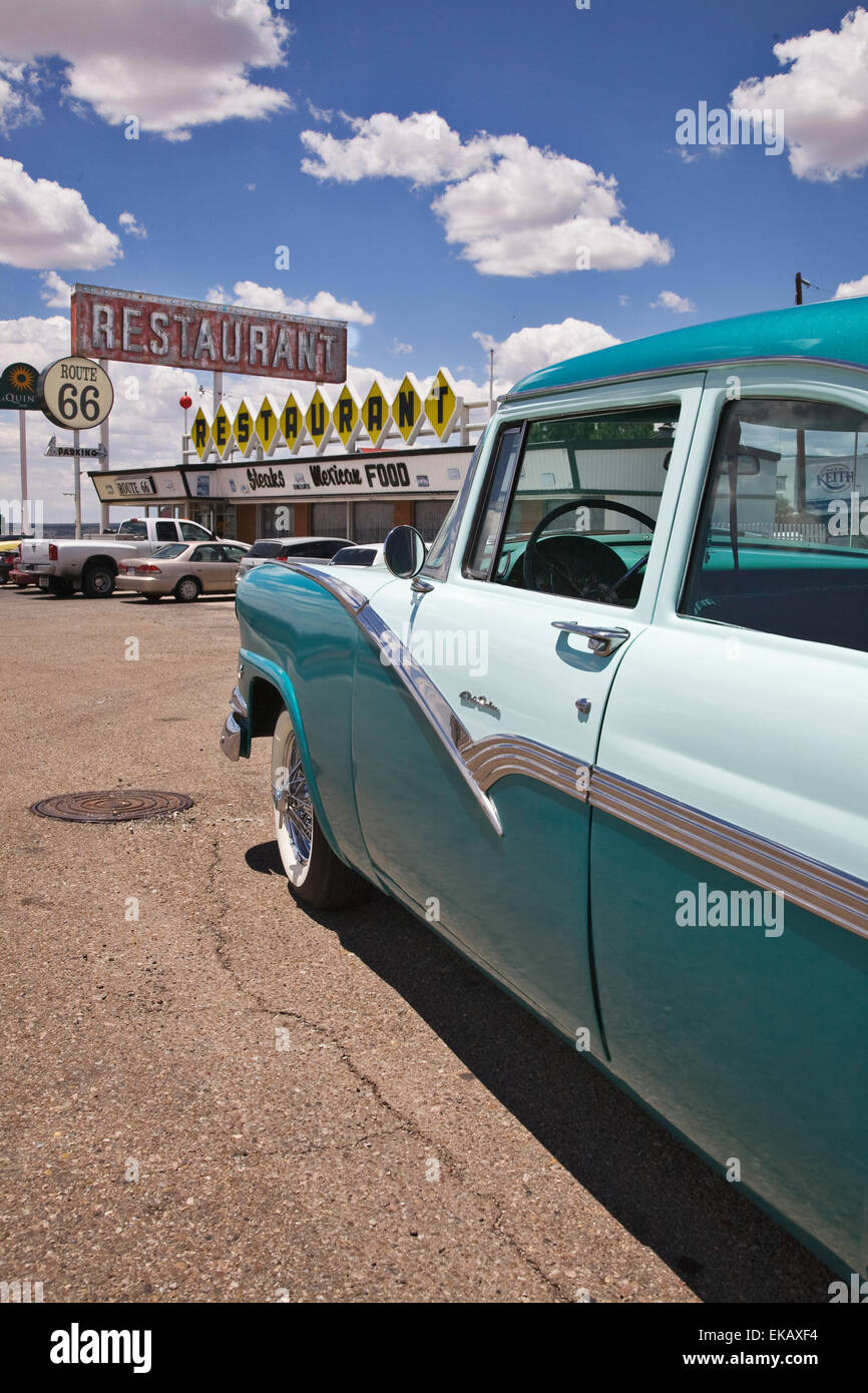 A two toned 1956 Ford Club Sedan gleams in the sun in front of  a period diner on Old Route 66 in Santa Rosa, New Mexico. Stock Photo