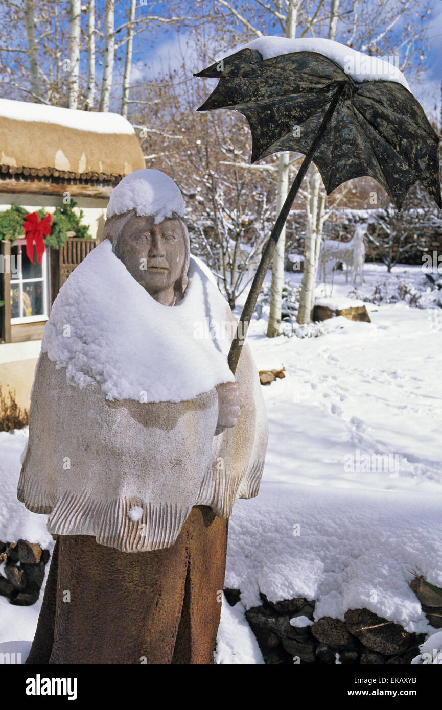 A sculpture by Doug Hyde seems even more quaint and colorful when covered with a coat of fresh snow in  Canyon Road in Santa Fe. Stock Photo