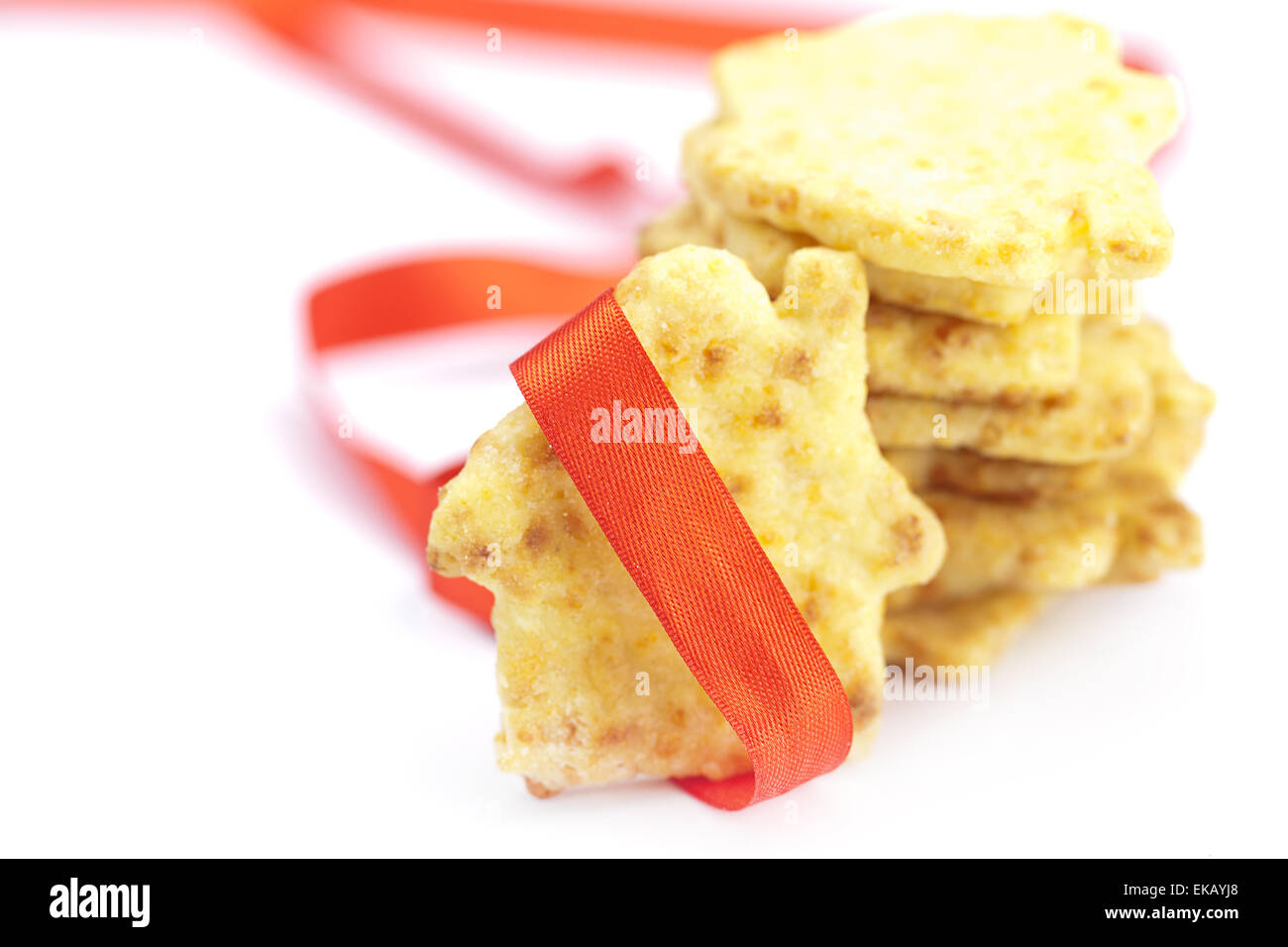 Cookies in the form of a house with red ribbon isolated on white Stock Photo