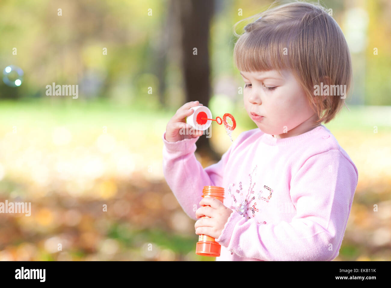 beautiful little girl making bubble blower on the autumn forest Stock ...