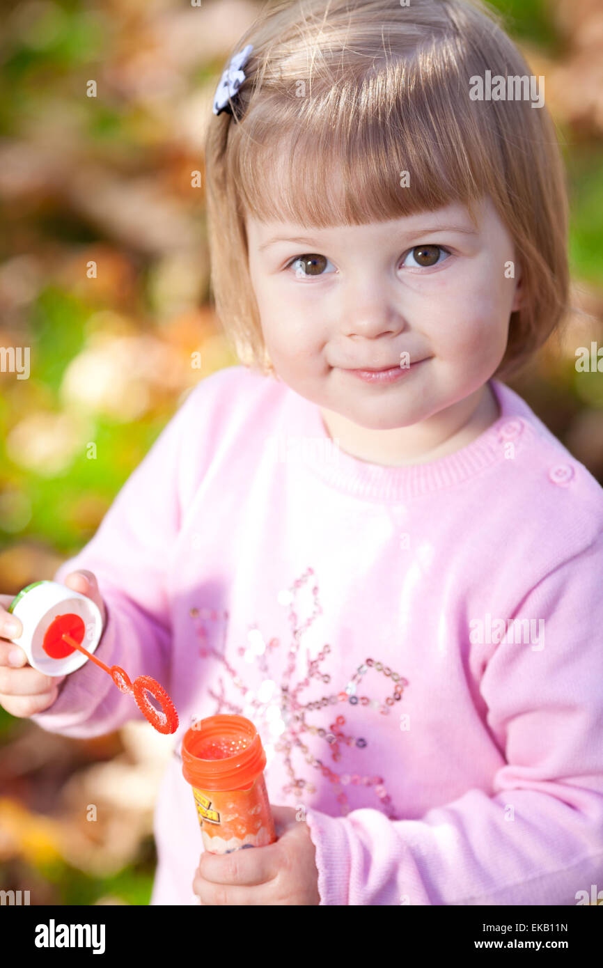 beautiful little girl making bubble blower on the autumn forest Stock ...