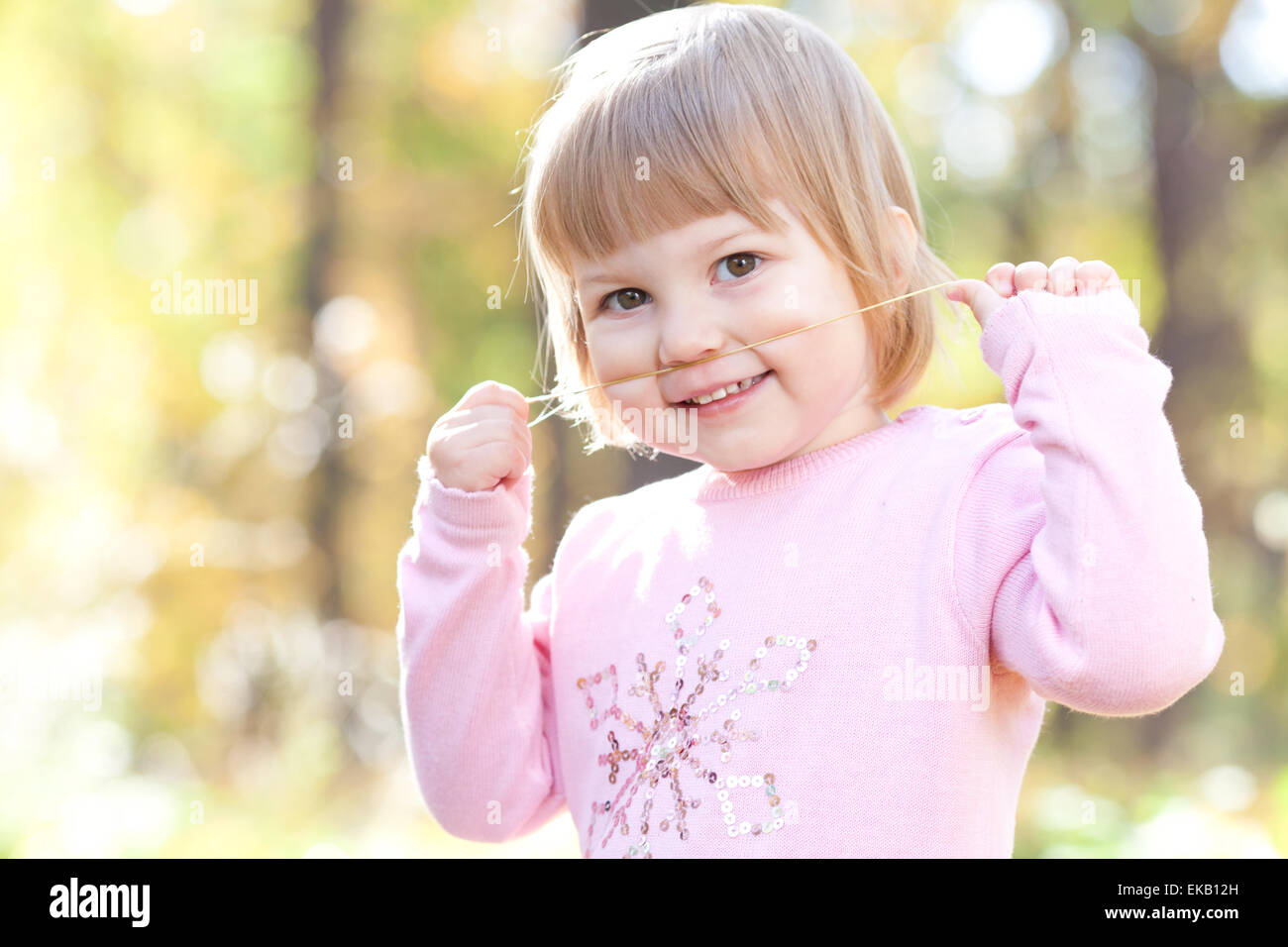 beautiful little girl on the autumn forest Stock Photo - Alamy