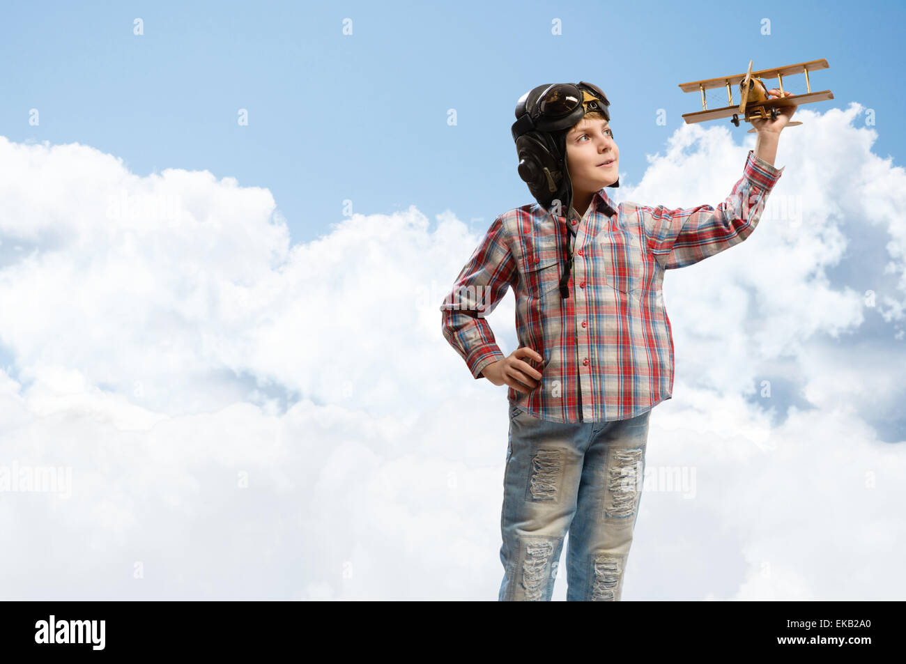 Boy in helmet pilot playing with a toy airplane Stock Photo - Alamy