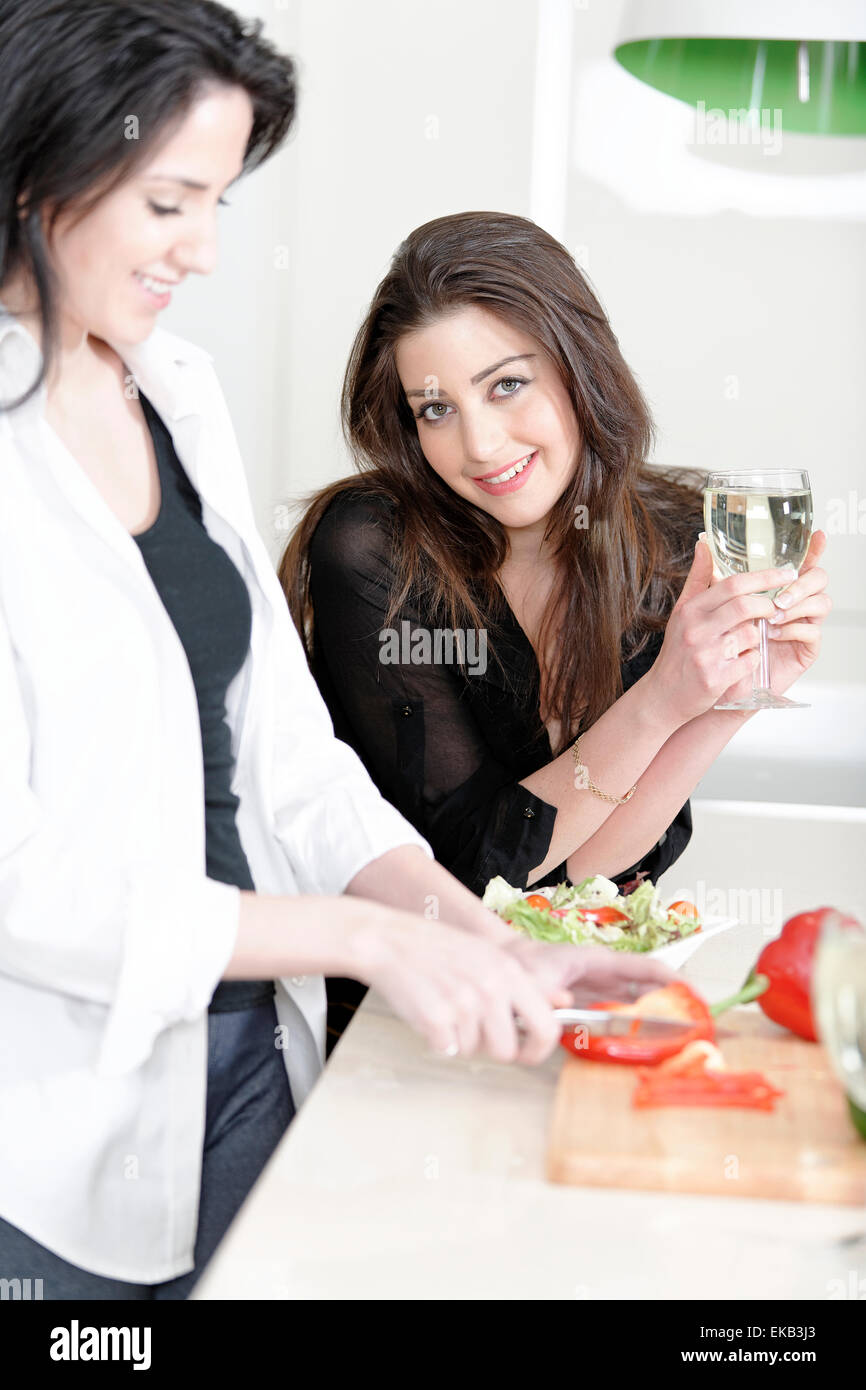 Two friends in a kitchen cooking Stock Photo - Alamy