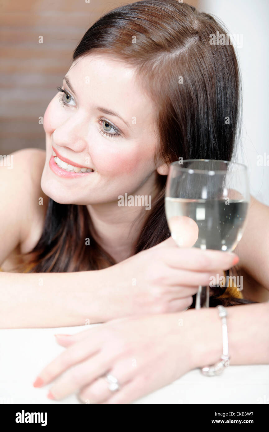 Woman relaxing on her sofa with a drink Stock Photo - Alamy