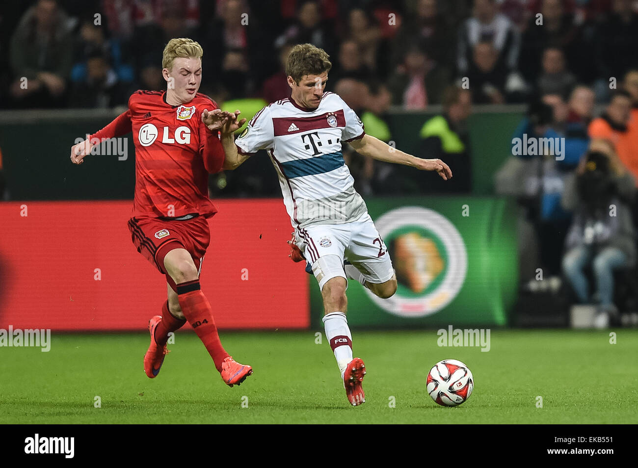 Munich's Thomas Müller (R) and Leverkusen's Julian Brandt in action during the German DFB Cup quarter final soccer match between Bayer Leverkusen and Bayern Munich at the BayArena in Leverkusen, Germany, 08 April 2015. (ATTENTION: The DFB prohibits the utilisation and publication of sequential pictures on the internet and other online media during the match (including half-time). ATTENTION: BLOCKING PERIOD! The DFB permits the further utilisation and publication of the pictures for mobile services (especially MMS) and for DVB-H and DMB only after the end of the match.) Photo: Maja Hitij/dpa Stock Photo
