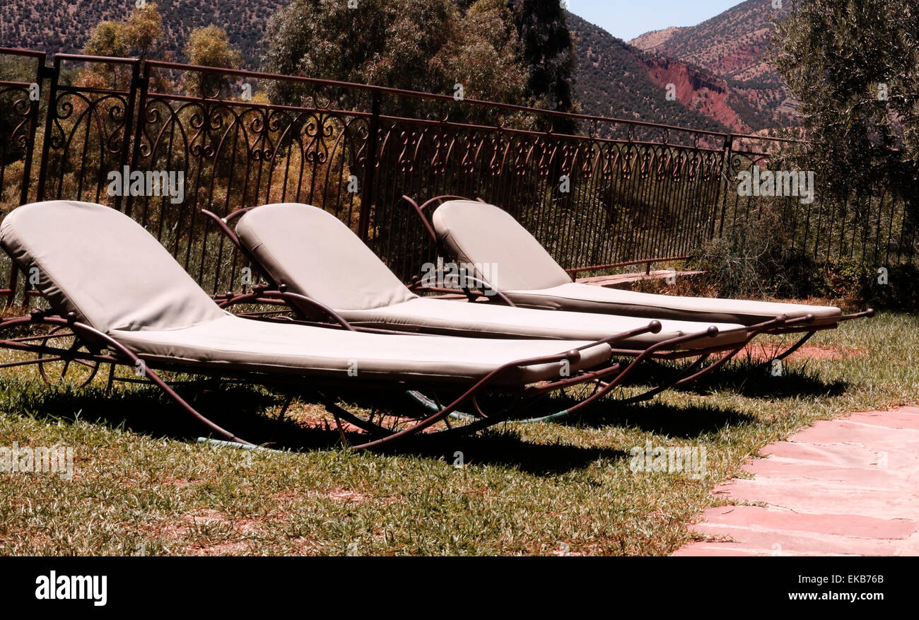 Three reclining sun loungers in a row, Atlas Mountains, Moroccol Stock Photo