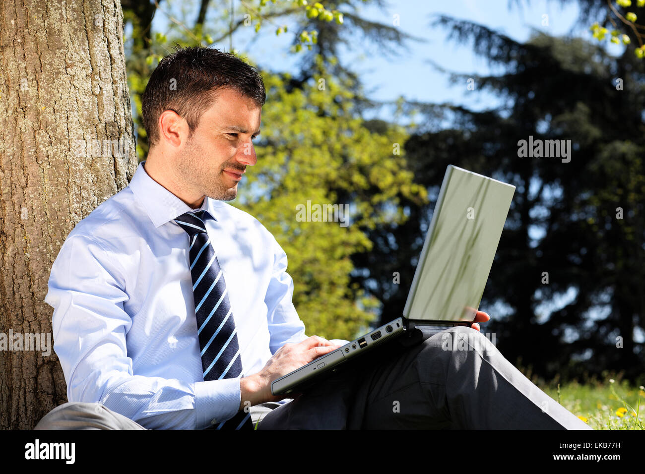 man with computer in a park Stock Photo - Alamy