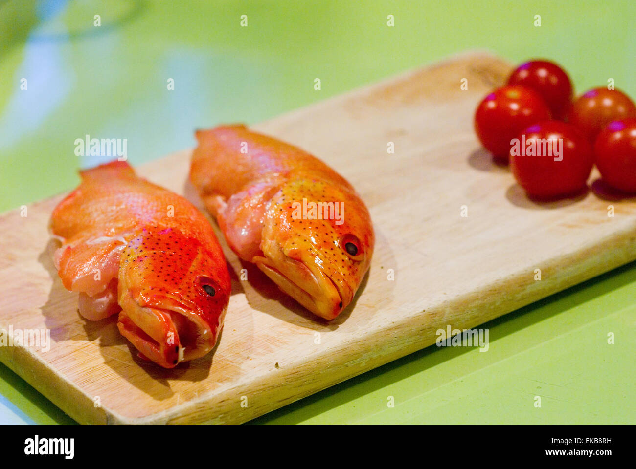 colourfull, vivid butterfish heads with teeth showing on a cutting