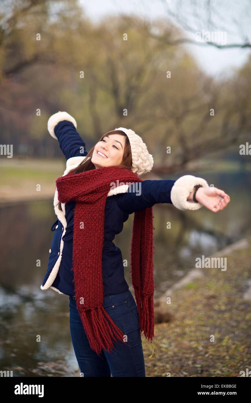 Beautiful mixed race Girl stretching arms to relax in winter Stock Photo